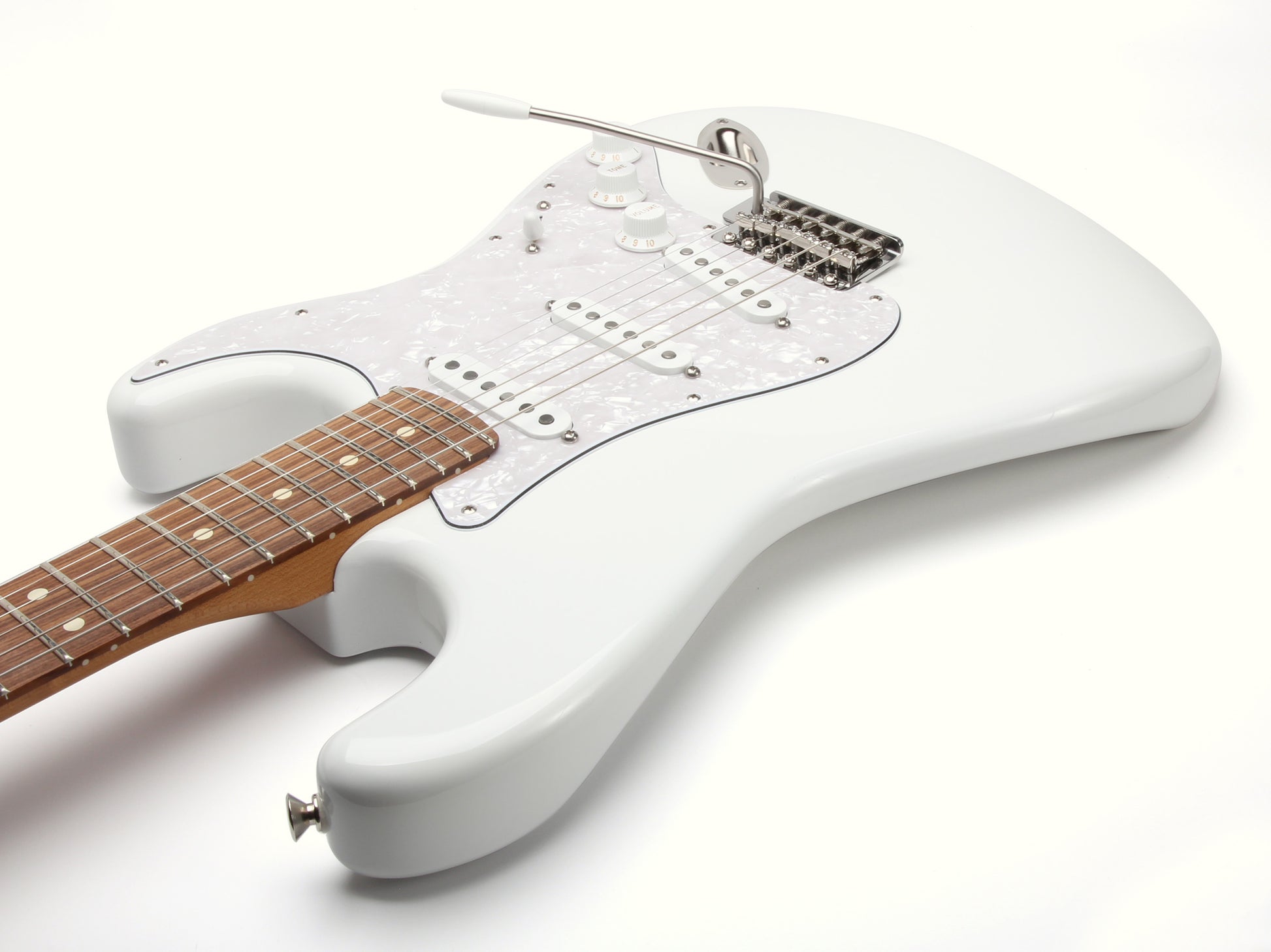White electric guitar with a wooden fretboard on a white background