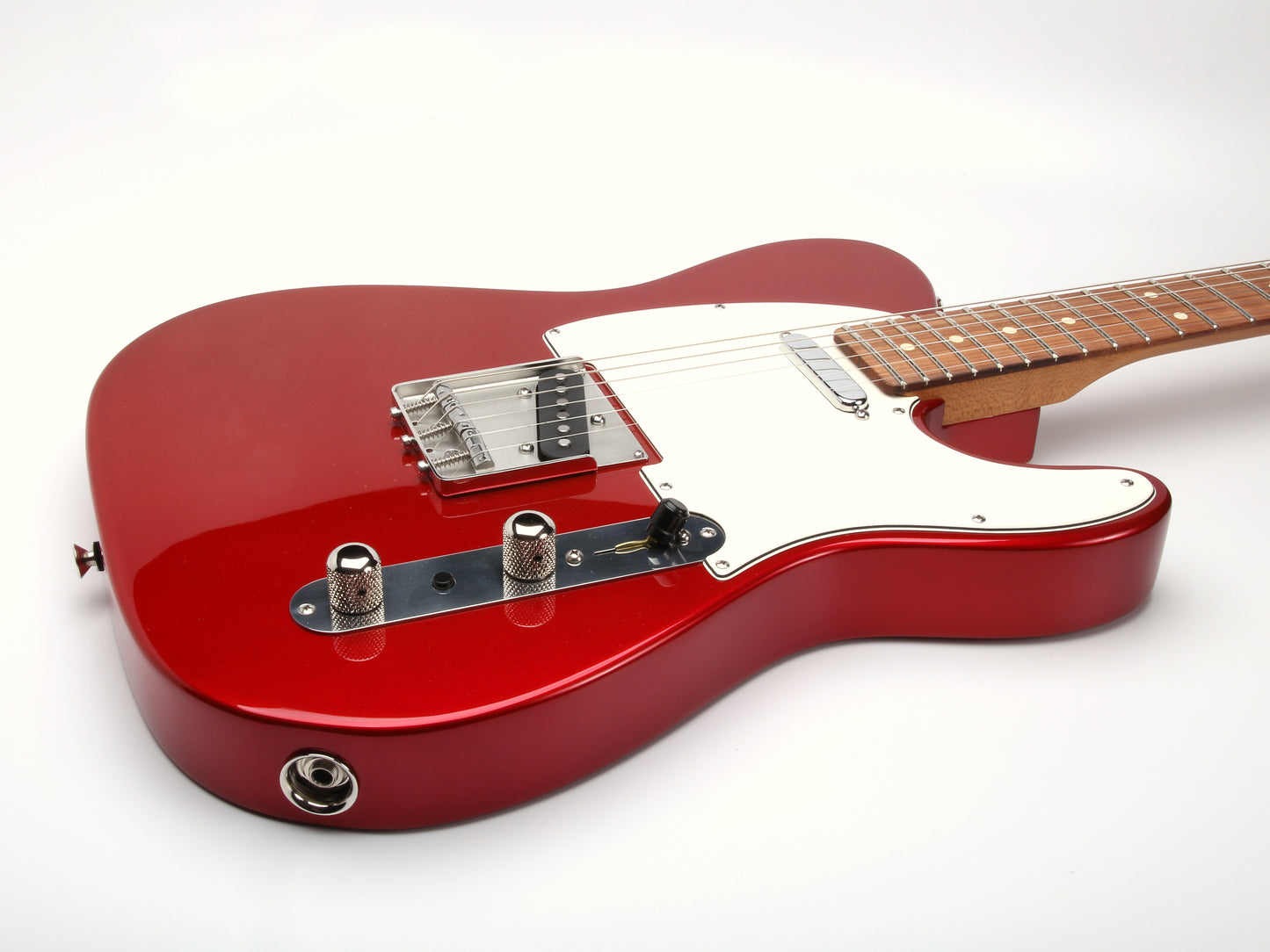 Red electric guitar on a white background