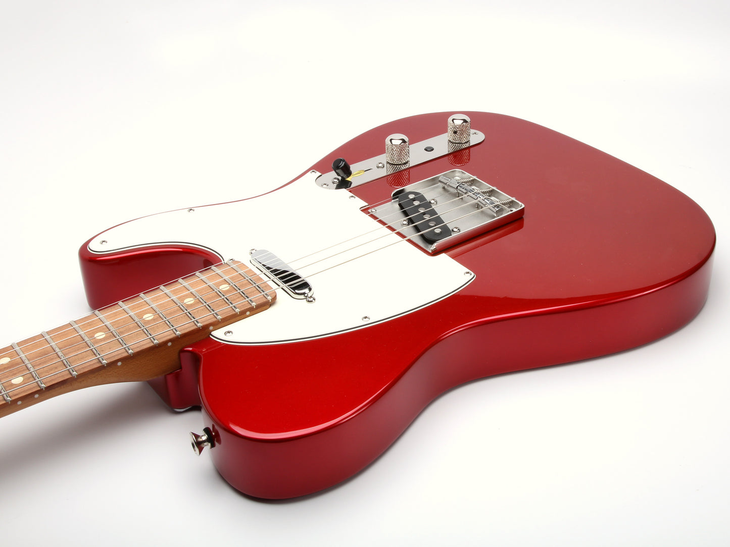 Red electric guitar on a white background